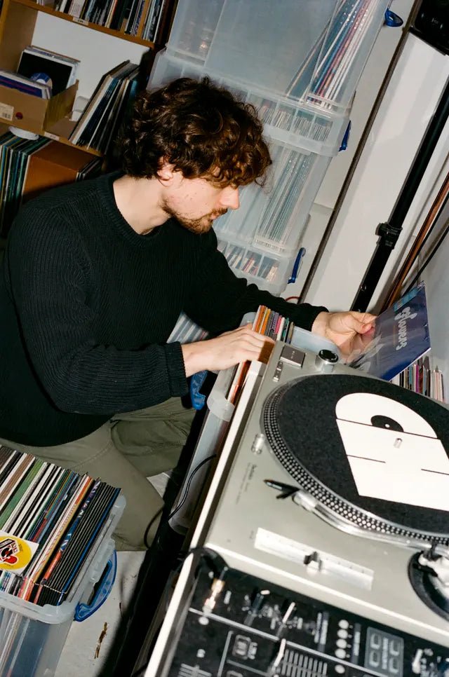Billy’s hands selecting a record beside the ColdCuts // HotWax turntable
